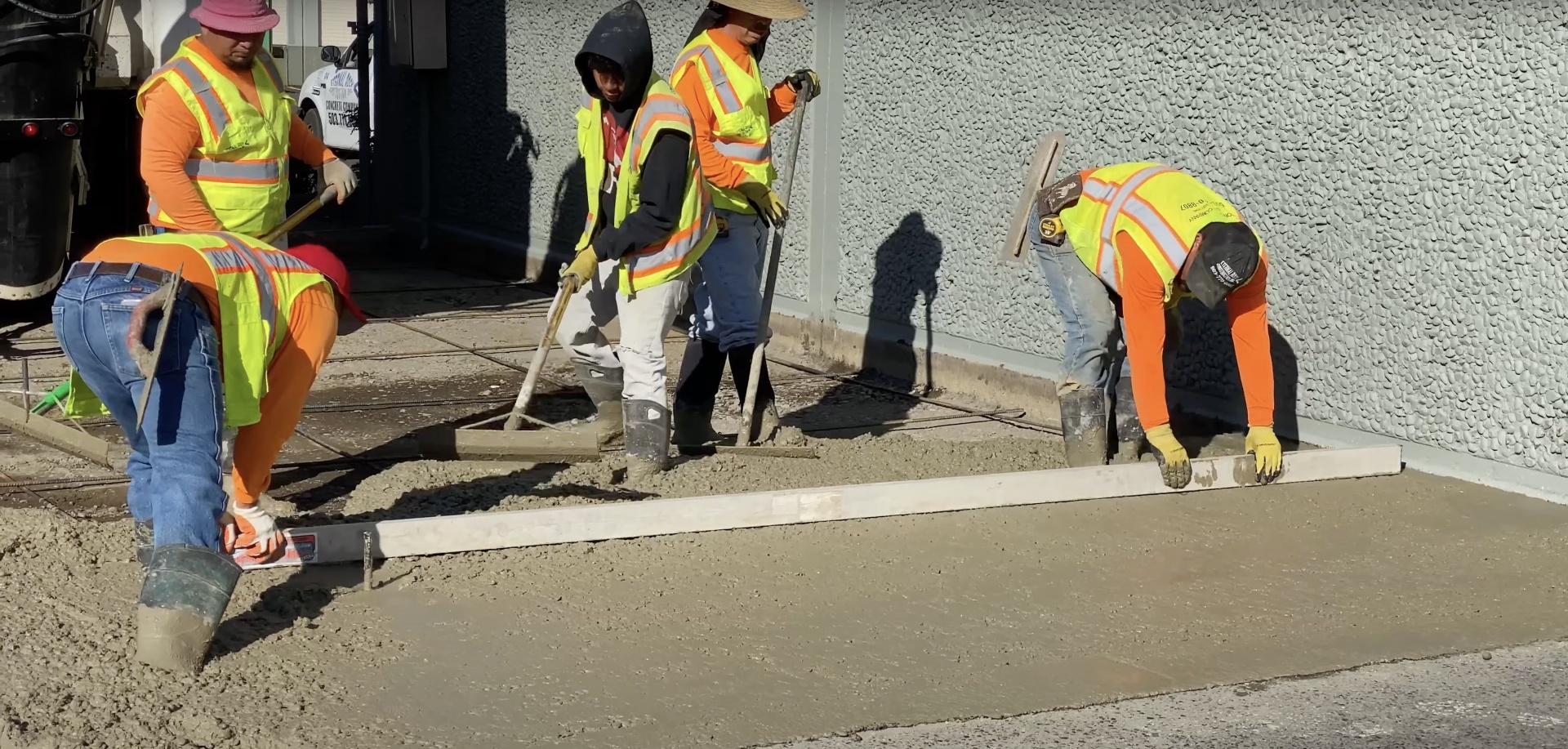 Professional concrete finishing crew working on smooth concrete surface in Grapevine, TX