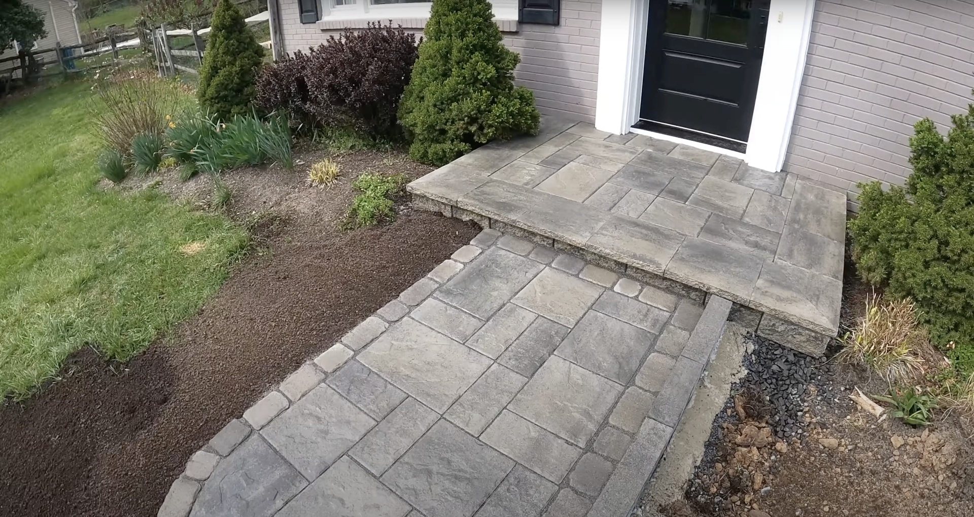 Finished concrete patio with beautiful landscaping and professional design in Grapevine, TX