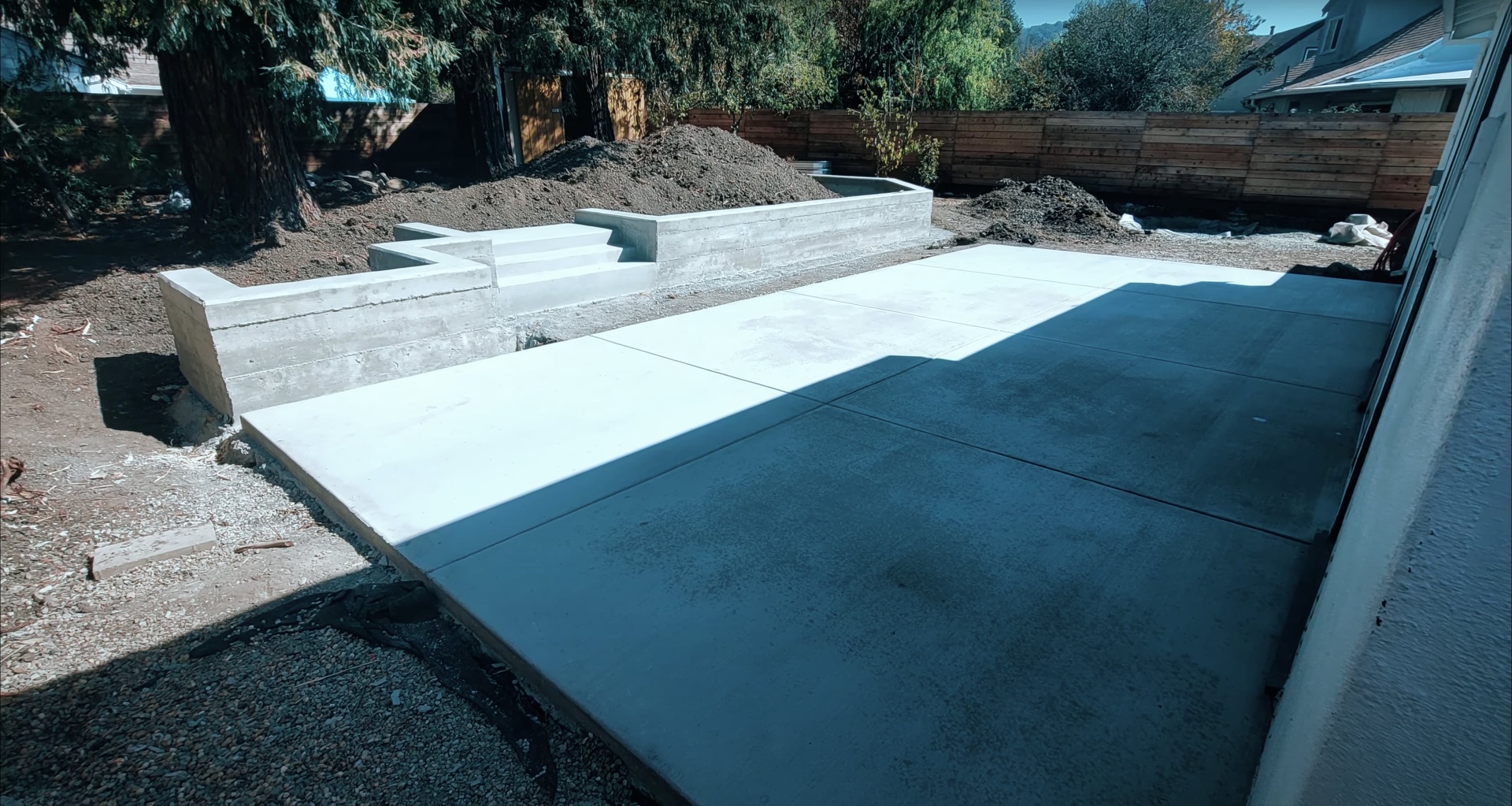 Concrete pool deck and swimming pool construction showing waterproofing and foundation work